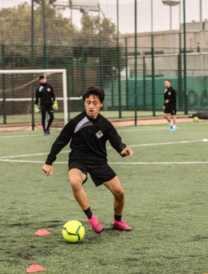 student playing soccer